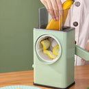 Green manual vegetable spiralizer being used to slice a banana on a wooden surface.