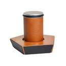 A wooden coffee tamper with a silver metal top and a black rubber seal, set in a hexagonal wooden holder with a black front panel.
