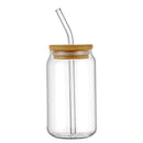 Clear glass jar with a bamboo lid and straw on a white background