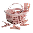 Pink plastic laundry basket and matching clothes clips shown on a light surface against a turquoise background, with a pink label indicating 30 pieces.
