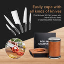 A set of stainless steel kitchen knives with silver handles is shown floating above a wooden surface next to a black sharpening box and a copper-and-silver rolling sharpening stone. Text on the image reads 'Easily cope with all kinds of knives' and 'Fruit knives, kitchen knives, etc.