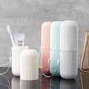 Set of three ribbed ceramic containers in white, pink, and blue on a reflective surface with a gray background.