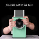 Green device with a large suction cup base held by hands on a black background